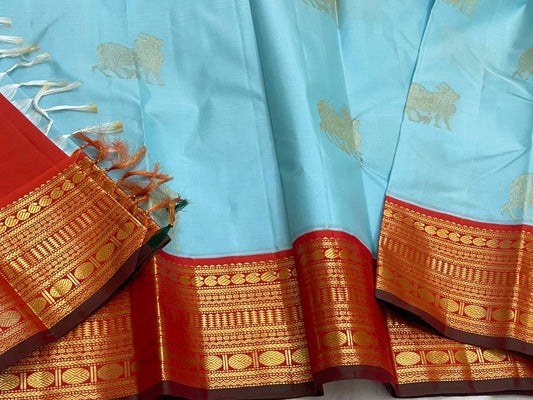 Kamadhenu — Pure Silk Kanchipuram
Sky-blue body with gold Kamadhenu motifs, fiery-orange pallu & ruby-red korvai borders ✨
Silk Mark Certified • Antique Zari Weave • Ships in Two Weeks • Free Shipping within USA