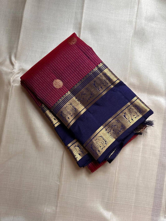 Anuraaga – Neelam
 — Pure Kanchipuram Silk
Vertical Pin-Stripe (Vairaoosi) Body • Gold Coin Buttas
Navy (Neelam) Korvai Border with Elephant Motifs
Diamond-Jaal Brocade Pallu • Running Contrast Blouse
Silk Mark Certified • free shipping in Two Weeks