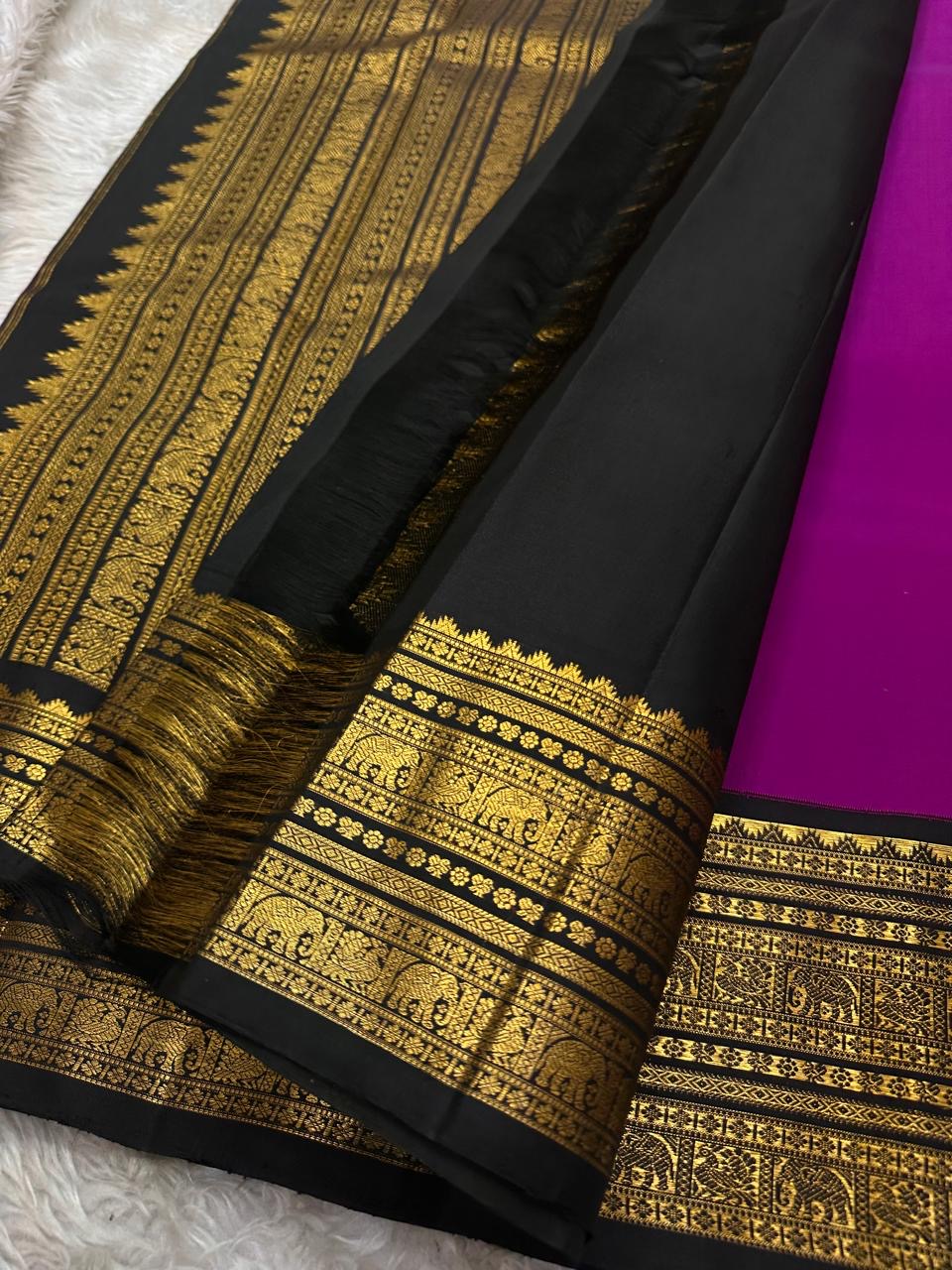 Menaka ✨ Draped in vibrant purple , its body shines with golden Yazhi motifs enshrined in Sorgavaasal arches. The contrasting black Korvai border, alive with elephants, vines, and temple motifs in zari and lavish Pallu , silk mark certified ❤️