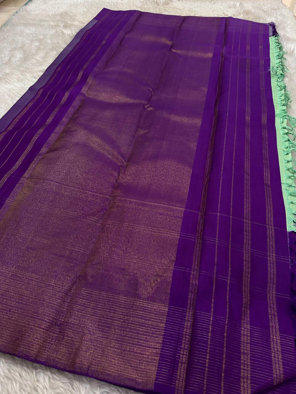 Ashva ✨ – Violet & Mint Pure Silk Kanchipuram Saree
Gold Zari Horse & Rooster Motifs in Kattam Checks
Linear Zari Border with Grand Violet Striped Pallu
Mint Green Blouse with Zari Border Included
Silk Mark Certified | Fall & Pico | Blouse Stitching ($30)
