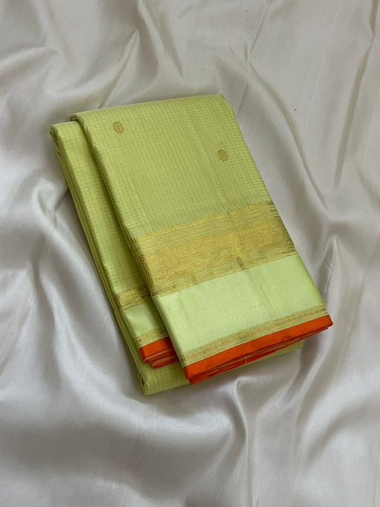 Meadow Shine — Kanchipuram Pure Silk Saree
Pastel meadow-green body with micro kattam checks & zari buttas
Antique zari borders woven with vine & elephant motifs
Warm kesari-orange selvedge a radiant edge . Silk mark cert. Free shipping within USA