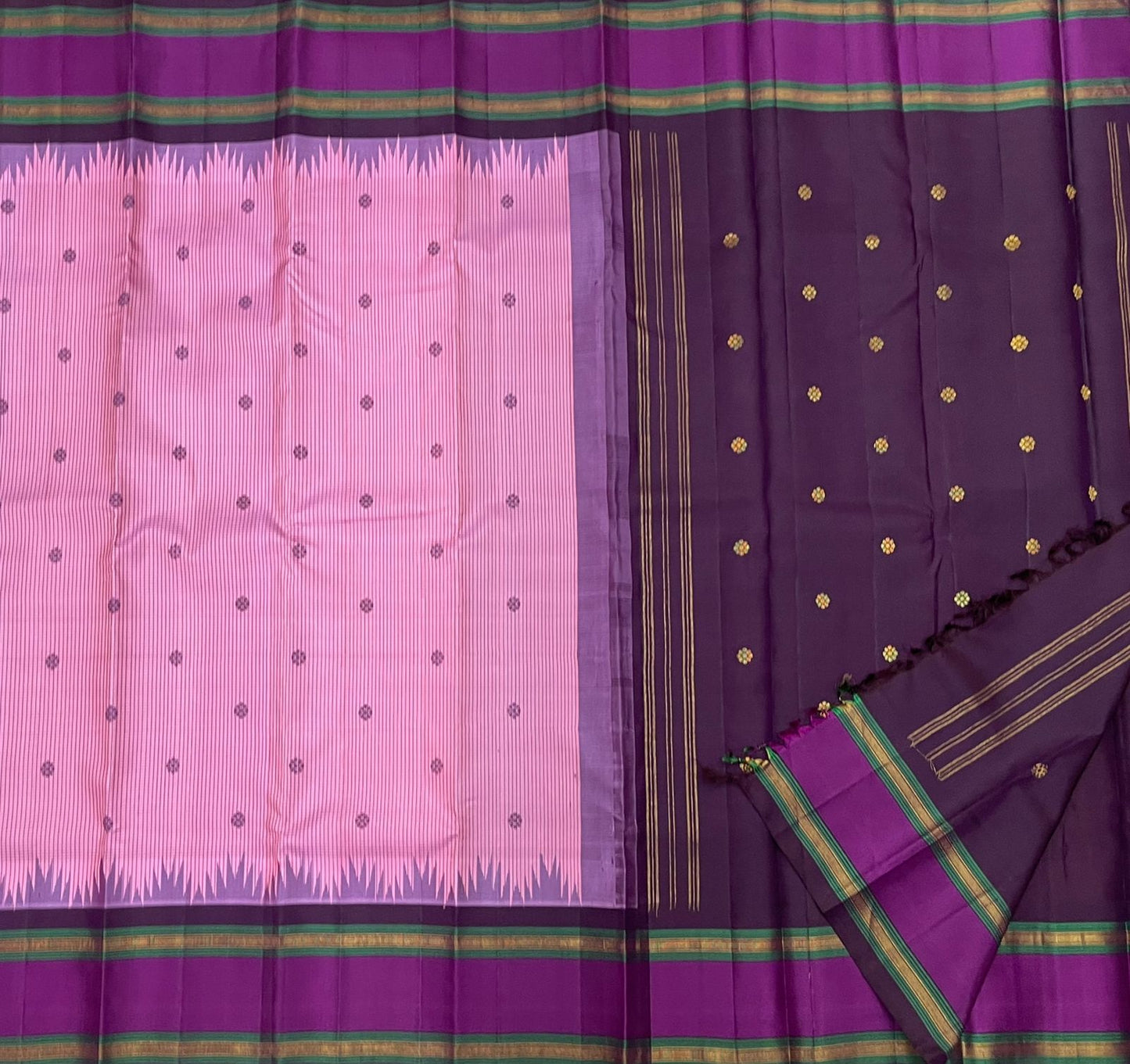 Vadamalli Reku kattam– Pure Silk Kanchipuram Saree
Plum-purple body with gold floral buttas & rettai-pettu borders
Pink checked reku pallu; contrast checked blouse included
Silk Mark Certified | Free Shipping within USA
Ships in 1 Week | Fall & Pico