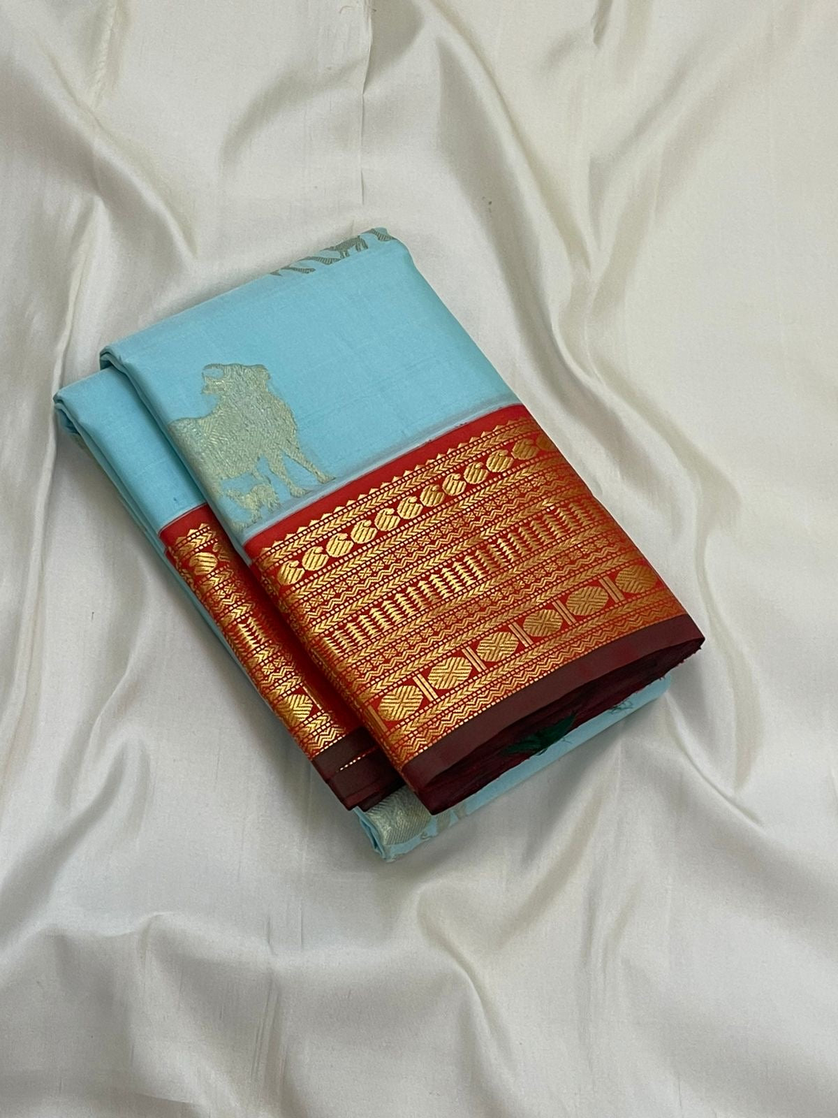Kamadhenu — Pure Silk Kanchipuram
Sky-blue body with gold Kamadhenu motifs, fiery-orange pallu & ruby-red korvai borders ✨
Silk Mark Certified • Antique Zari Weave • Ships in Two Weeks • Free Shipping within USA