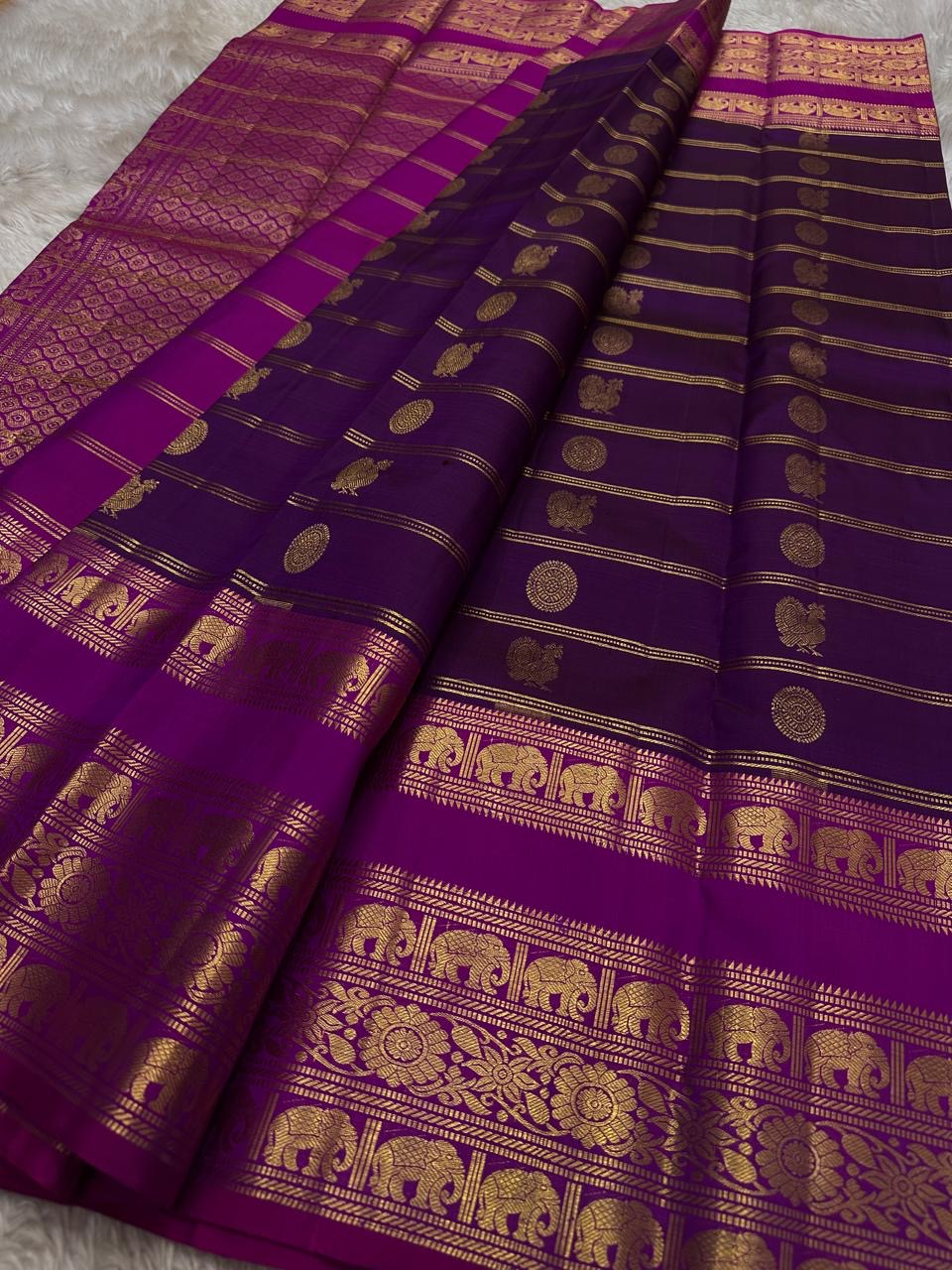 Rani Pink Plum Zari Stripes – Pure Kanchipuram Silk Saree
Plum purple body with rani-pink korvai borders & grand zari pallu
Elephants & floral mandalas woven in gold zari
Silk Mark Certified | Blouse Piece Included | Fall & Pico Done
Free shipping