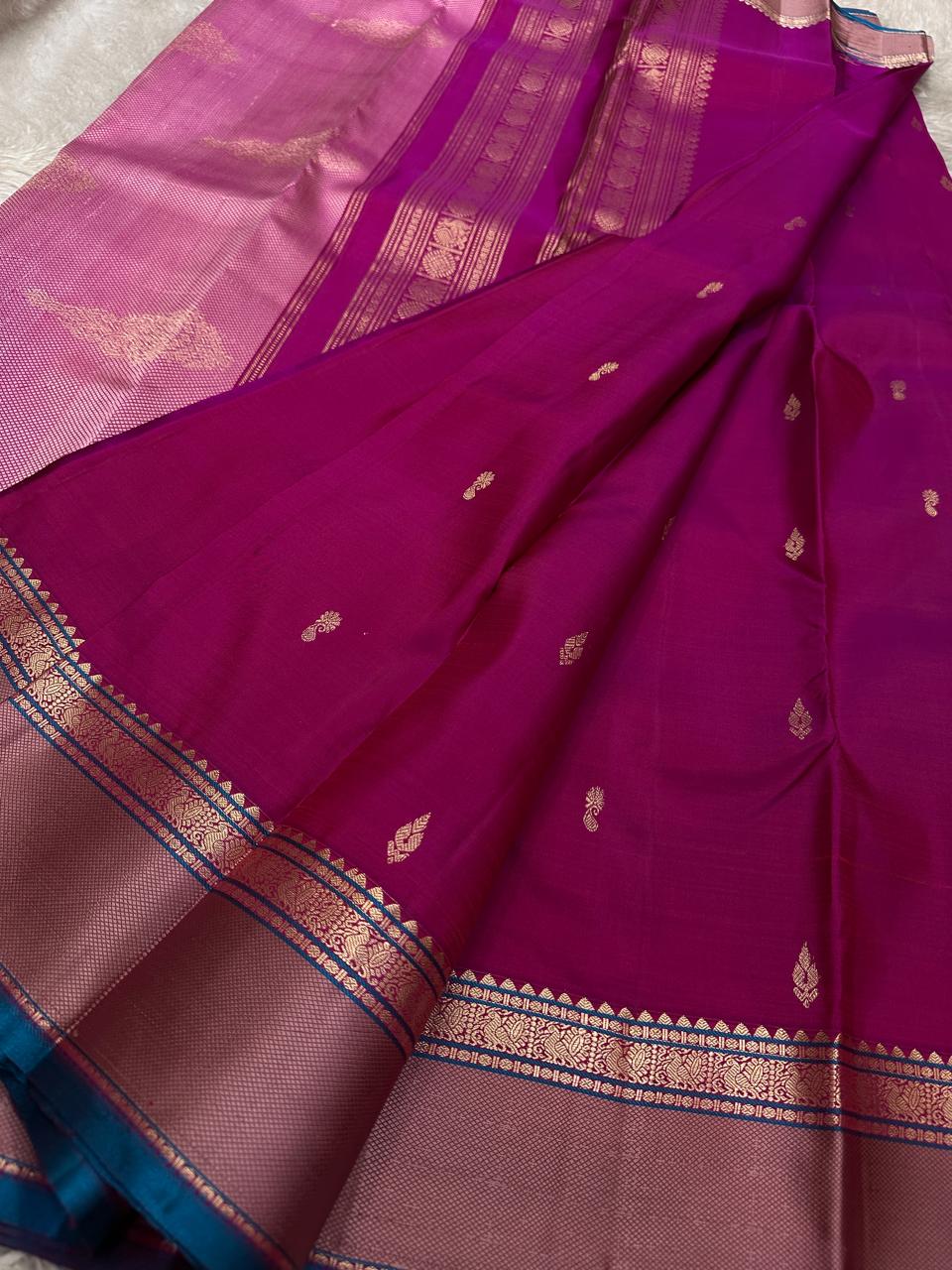 Pink Lily — Pure Silk Kanchipuram
Rani-pink body with zari buttas, dusty-mauve korvai borders & teal selvedge highlights ✨
Silk Mark Certified • Antique Zari Weave • Ships in Two Weeks • Free Shipping within USA