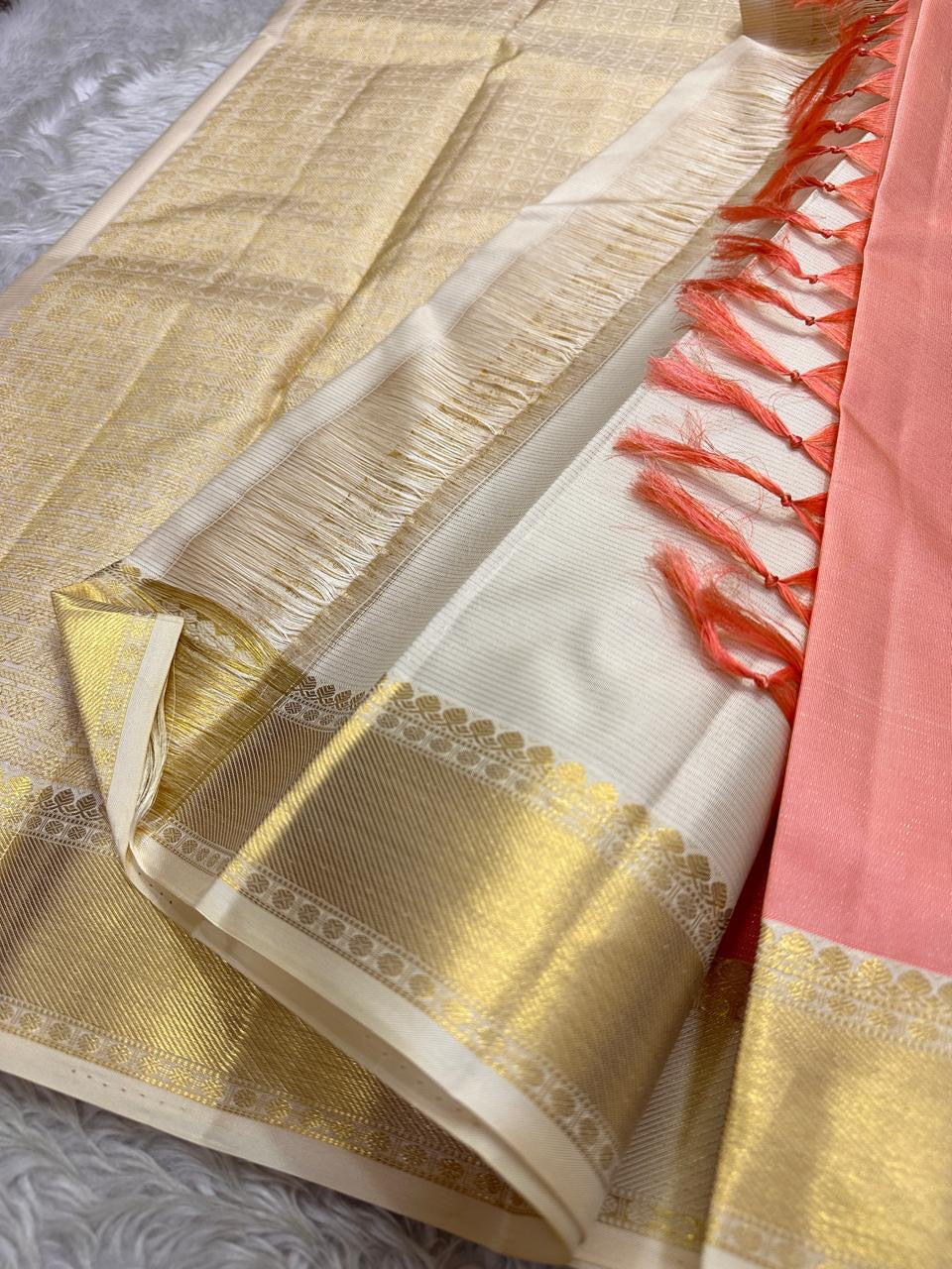 Ivory Blush Meadow – Pure Kanchipuram Silk Saree
Blush-Peach Body with Gold Zari Animal Buttas
Ivory-Gold Contrast Border with Floral Motifs
Grand Ivory-Gold Brocade Pallu in Traditional Weave
Silk Mark Certified, delivery in 2 weeks