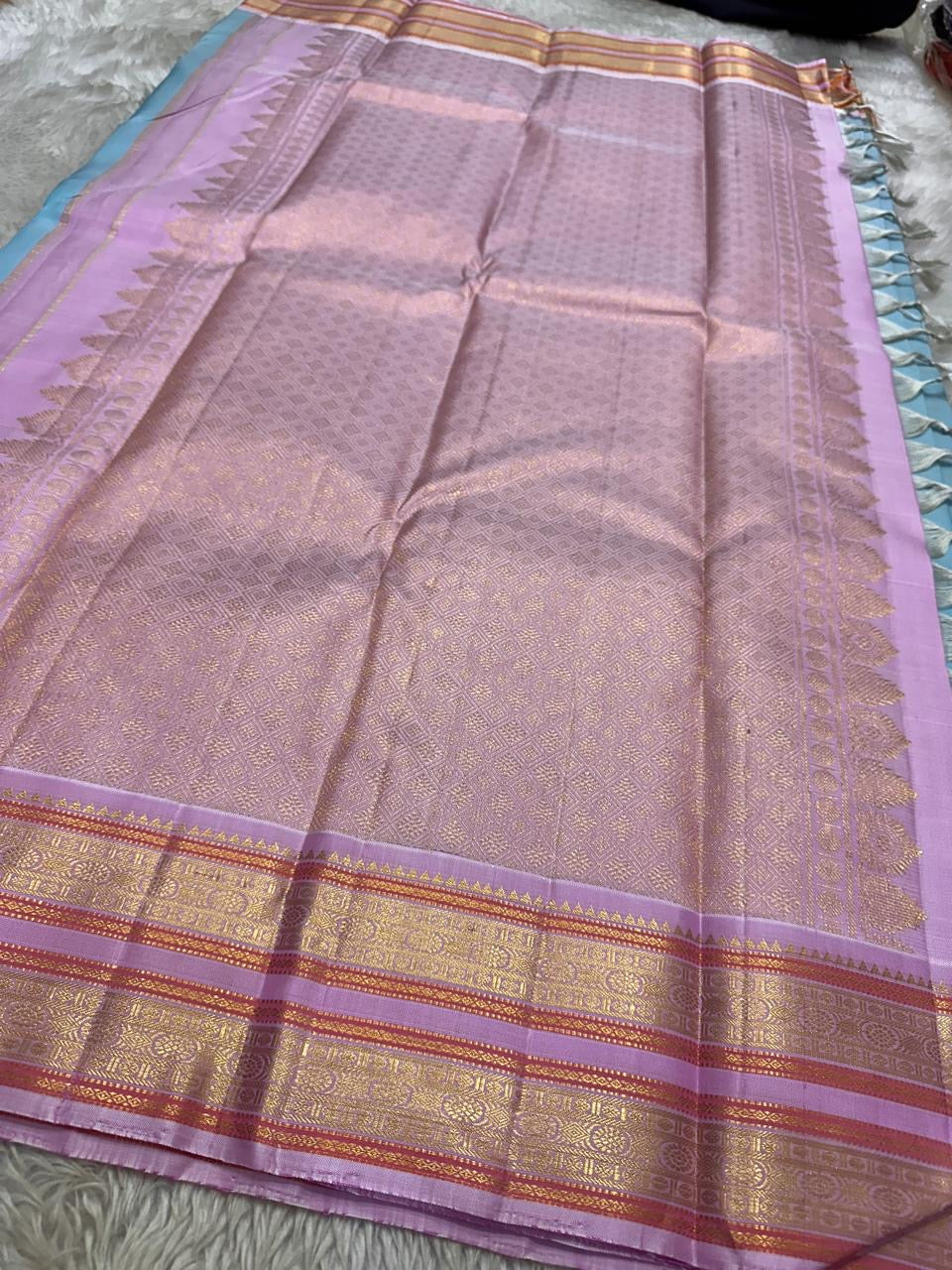 Nirvi – Sky Blue & Purple Kanchipuram Pure Silk Saree with Mayil & Yanai Zari Motifs
Graceful Harmony of Peacock & Elephant Motifs on Soothing Blue
Handwoven Elegance with Traditional Rettapet Border & Rich Zari Detailing