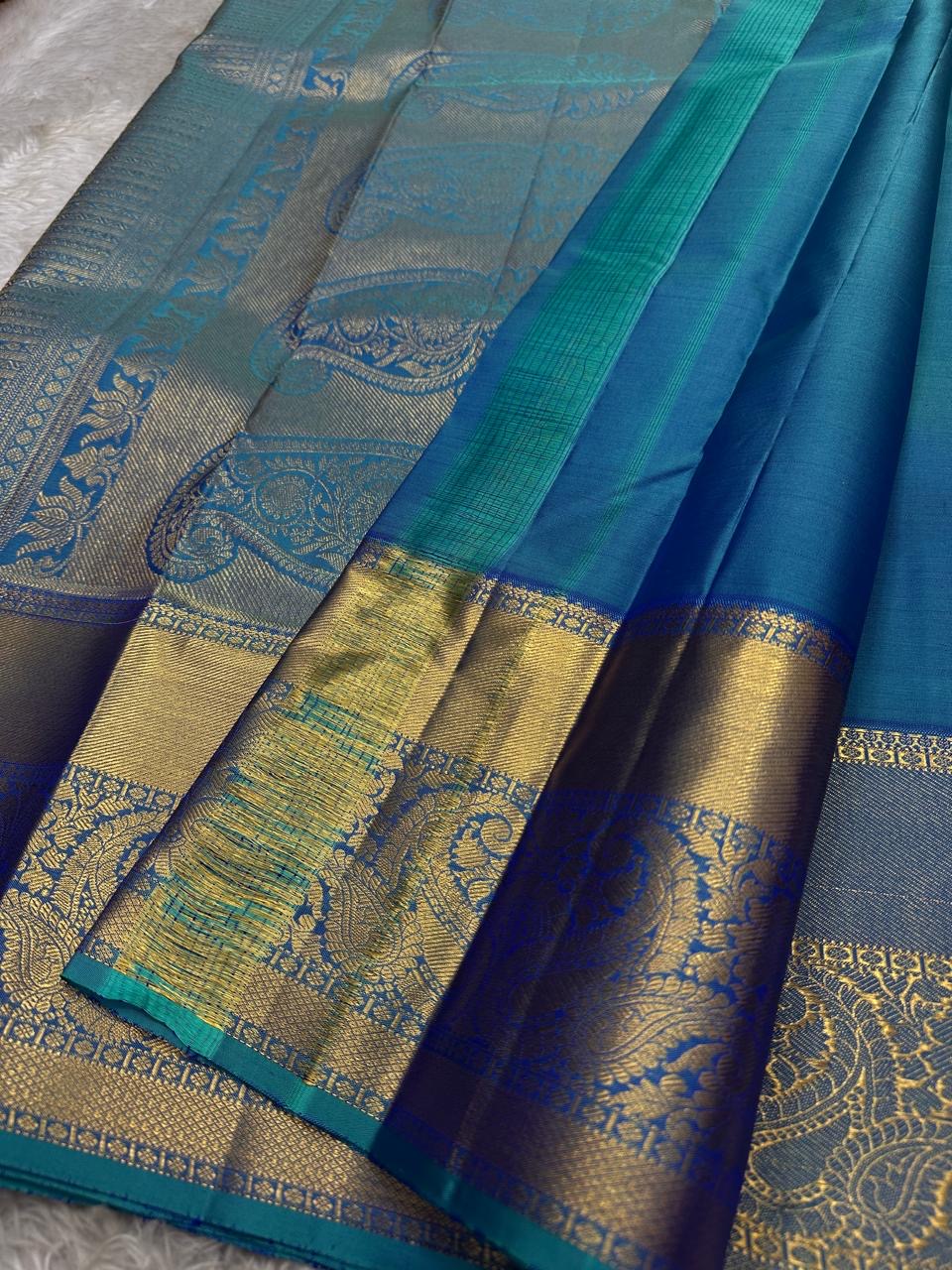 Pure silk KanchiPuram peacock blue with a shot of green elephant and Kamalam Zari checks saree