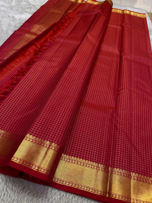 Kunguma Kattam — Pure Silk Kanchipuram Saree shot
Vermilion red body with zari kattam checks ✨
Broad golden zari borders with floral vines 🌸
Coppery-red brocade pallu with diamond jaal & tassels 🪔
Silk Mark Certified • Ships in Two Weeks • Free Shipping