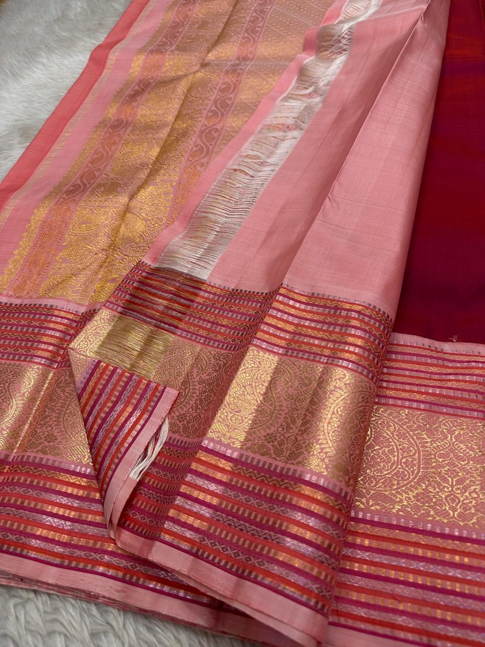 Red and pink pure silk Kanchipuram with the en vogue gold and silver zari border and Pallu