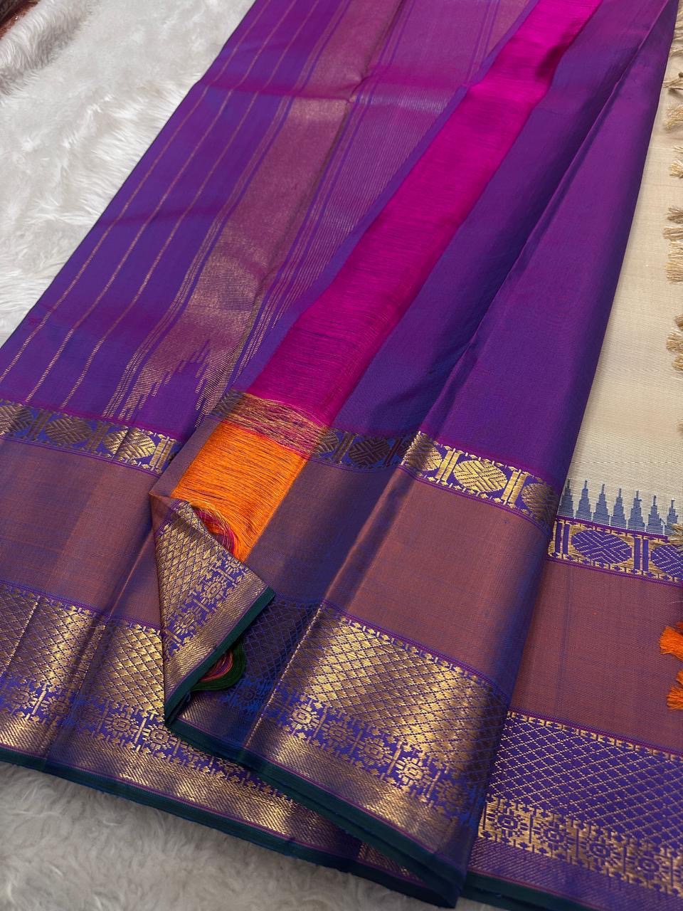 Vaidhehi – Ivory Kanchipuram Silk Saree
A classic ivory silk saree with a shot purple-orange Rudraksham border and a rich Thazhampoo reku pallu—timeless elegance woven with tradition