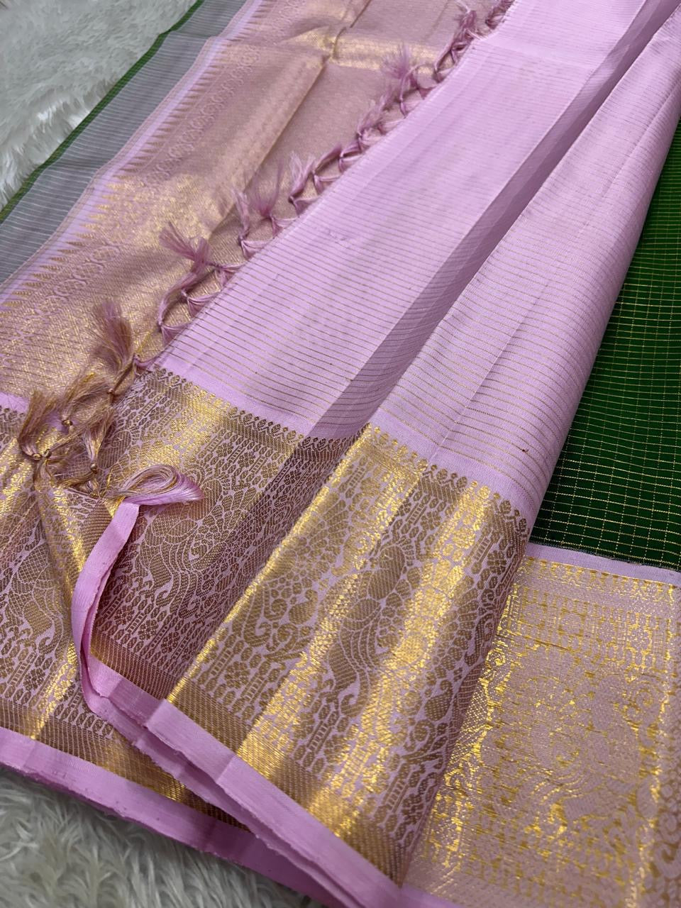 Vibrant green Zari kattam with pastel pink border peacock motif and Pallu