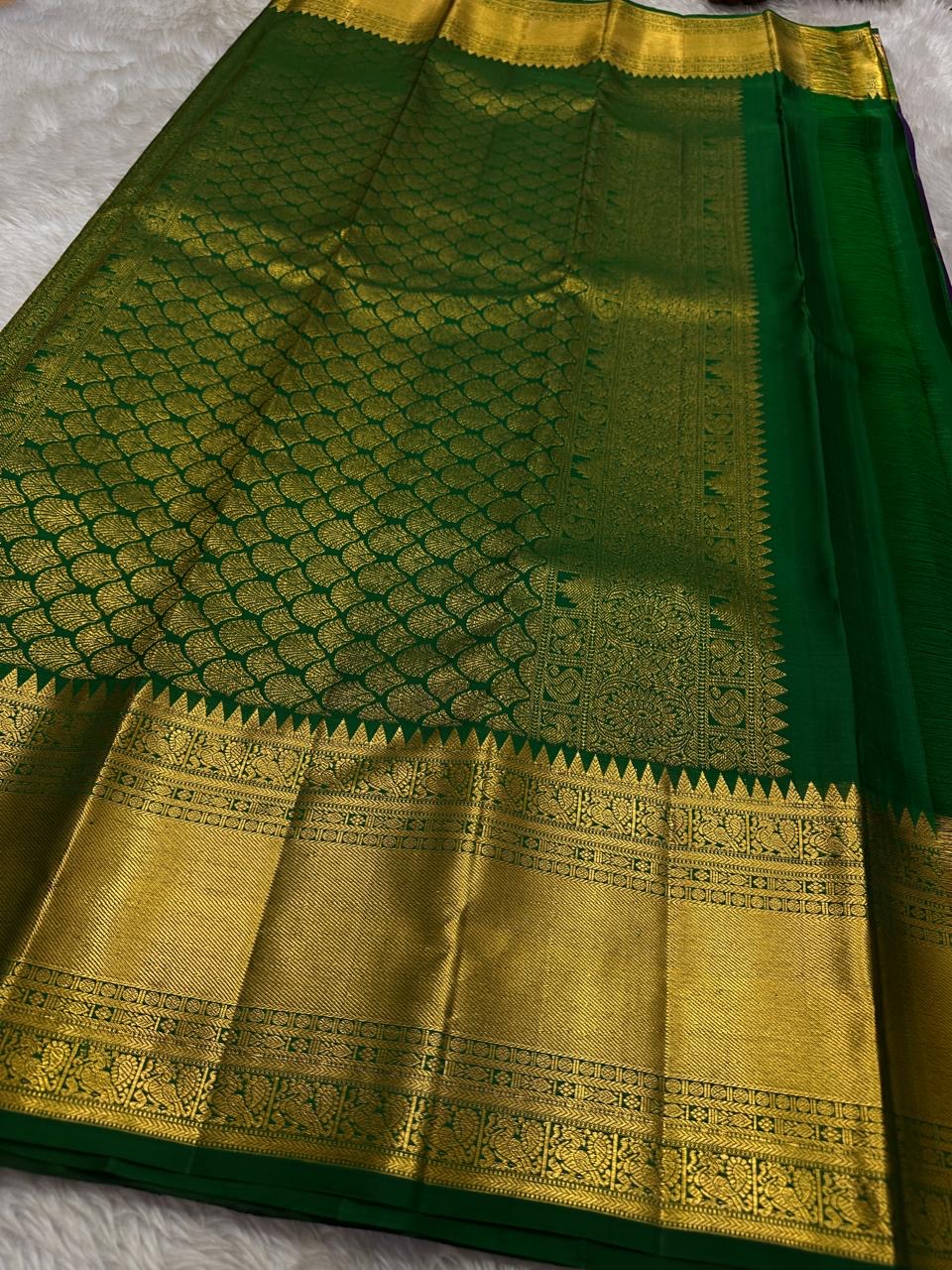 A majestic union of deep purple silk and emerald grace! Mayil chakram butta peacock border