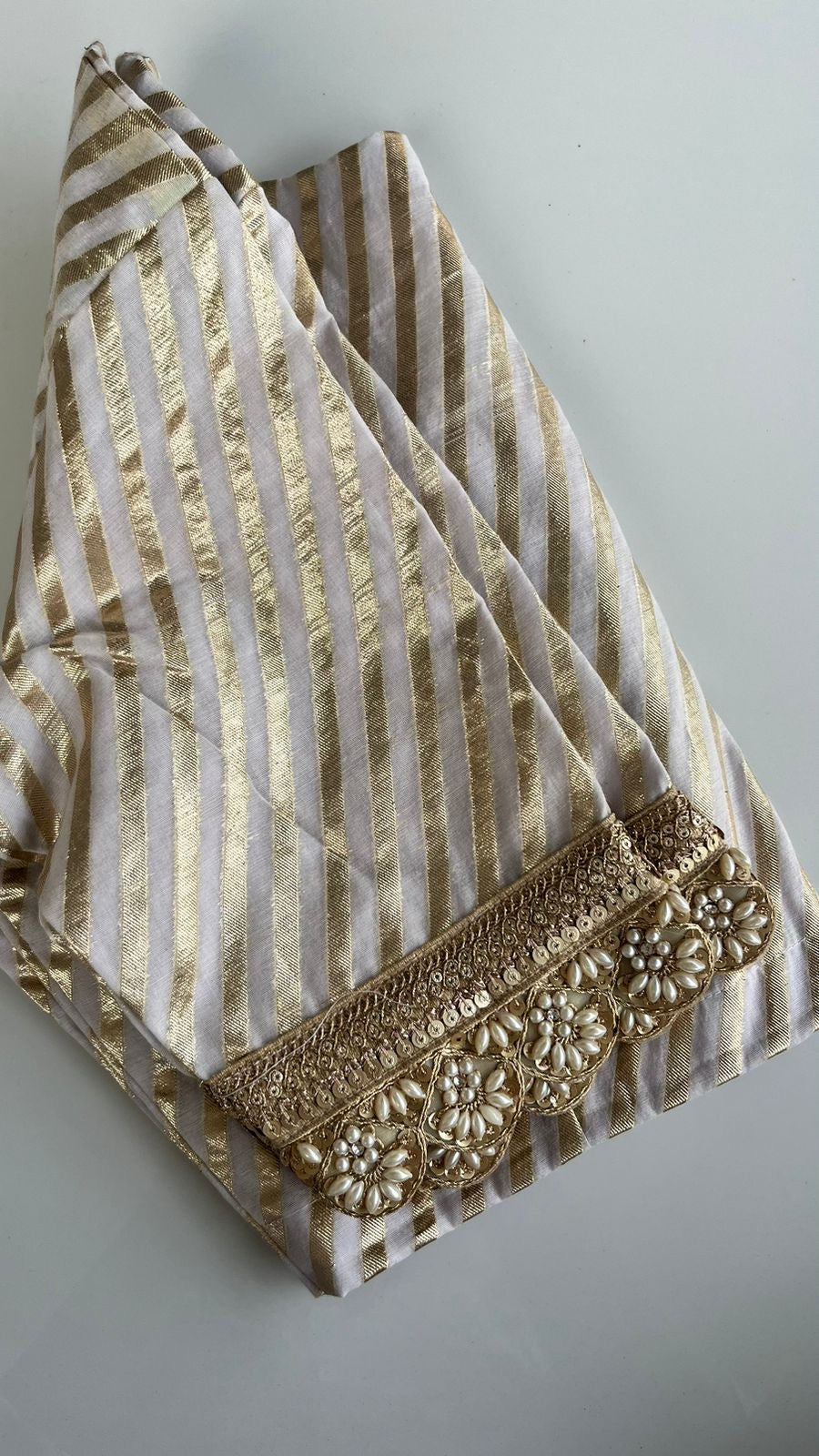 Banarasi soft silk blouse in leheriya pattern with hand embroidered sleeves in cream and gold