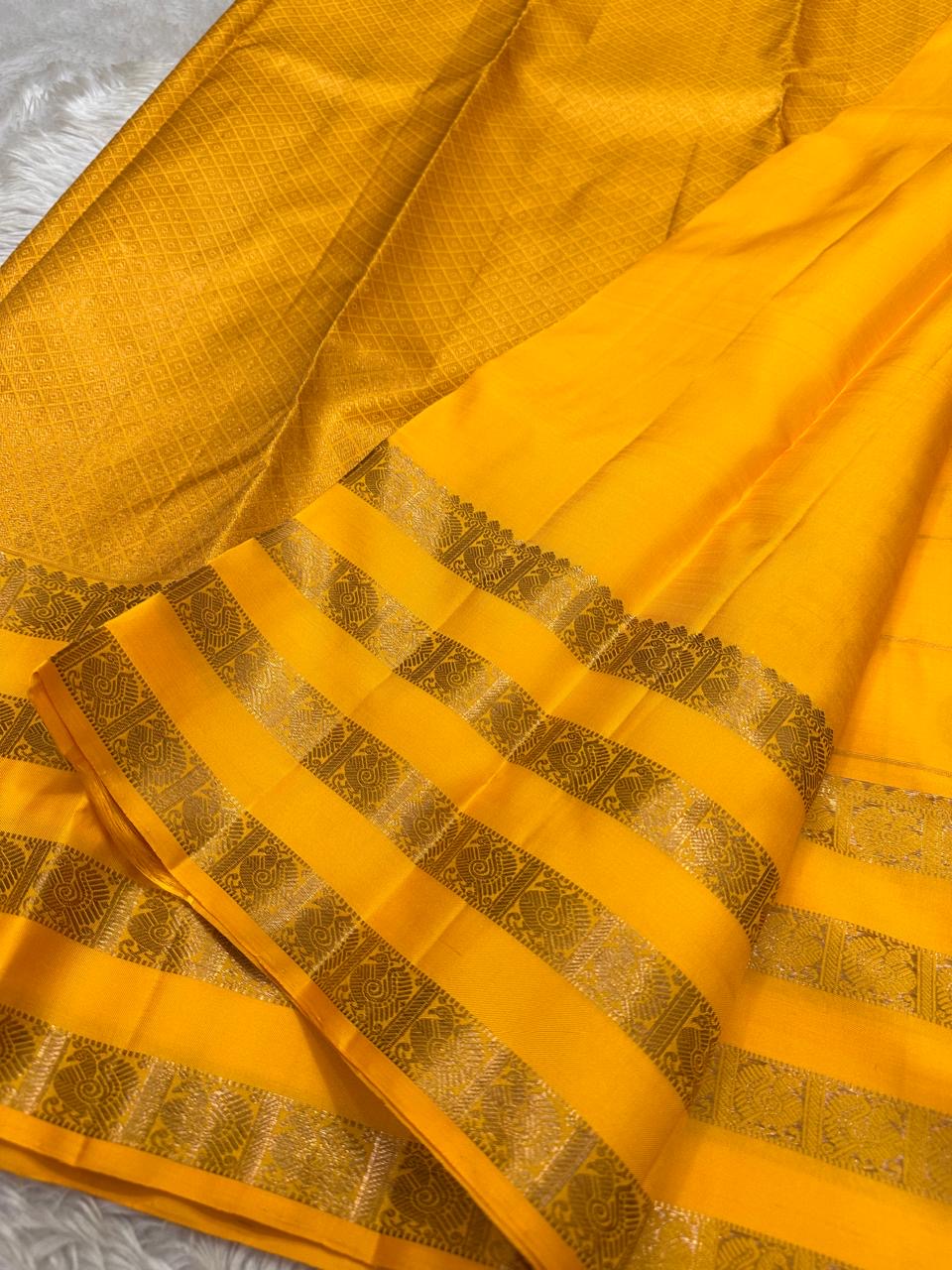 Kanaka – Sunlit Mustard Kanchipuram Silk Saree with Checked Zari Buttas and Gold Striped Border
A radiant weave that captures the warmth of tradition and the glow of celebration