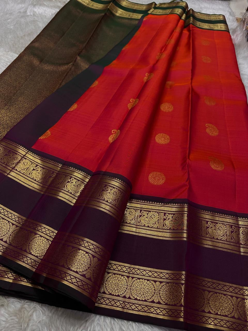 Vivid red shot deep pink with coffee brown Mayil Kamalam rettapettu border and butta paisley Zari woven butta on body pure silk Kanchipuram saree