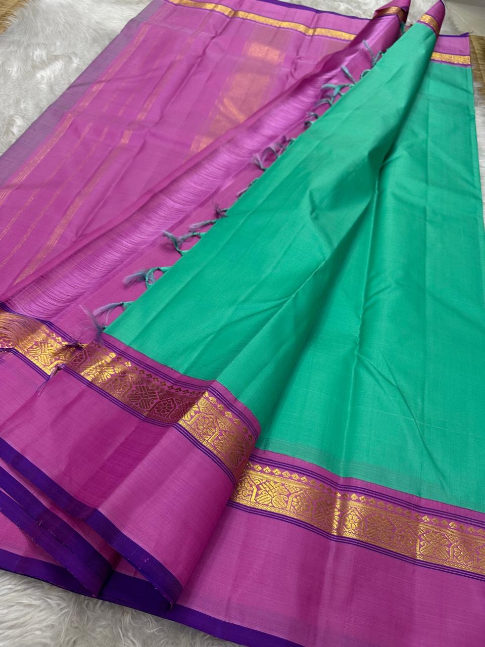 Jade Blossom – Pure Silk Kanchipuram Saree
Elegant Jade-Teal Body with Lustrous Weave 🌿
Rani-Magenta Contrast Border with Gold Zari ✨ purple selvedge
Grand Magenta Pallu in Lattice Design
Silk Mark Certified | ships in 2 weeks