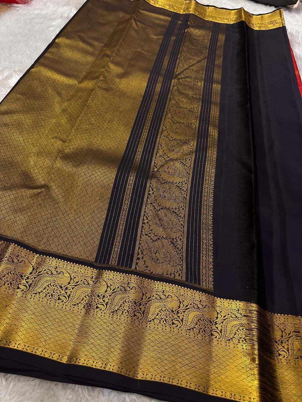 Vermilion red meets classic black. Fine kattam checks with coin buttas, peacock-zari borders and a regal black brocade pallu—made for Diwali lights, vows, and heirloom moments. Silk Mark Certified • Dispatch in 1 week • Free USA Shipping