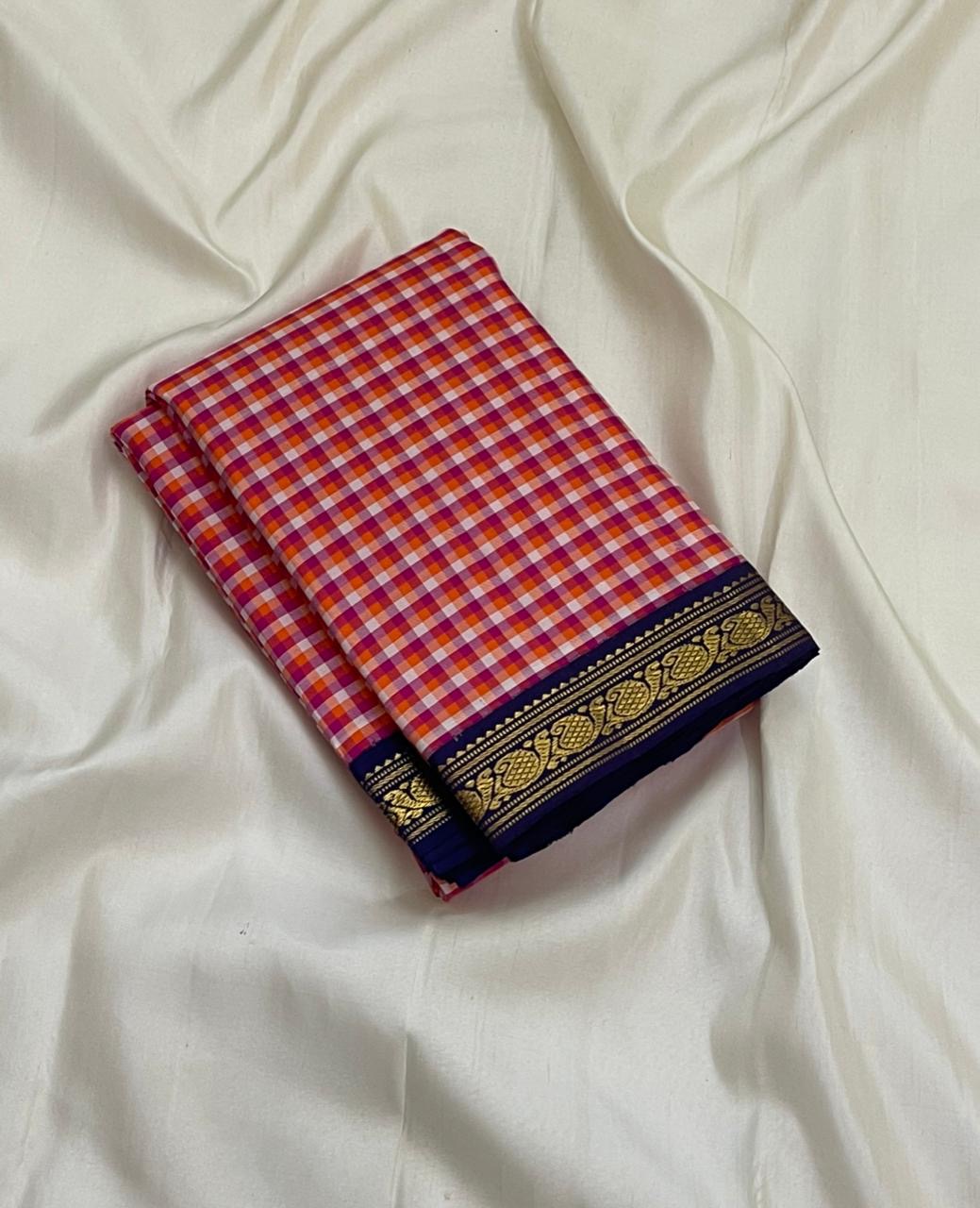 Rani Kanthi — Pure Silk Kanchipuram Saree
Sunset-orange, rani-pink & haldi-yellow kattam checks ✨
Navy korvai borders with intricate gold zari vines
Rich navy pallu with zari pinstripes & tasseled finish
Silk Mark Certified • Free USA Shipping in 1 week