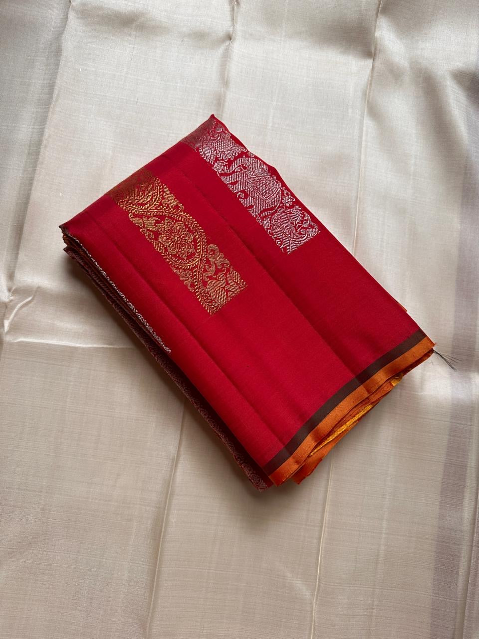 Lavanya– Vermillion Red Handwoven Kanchipuram Silk Saree in red with Gold & Silver Zari, this deep red Kanchipuram silk saree with intricate motifs in gold and silver zari, including Gandaberunda, parrots, elephants &lotuses as seen on Nita Ambani
