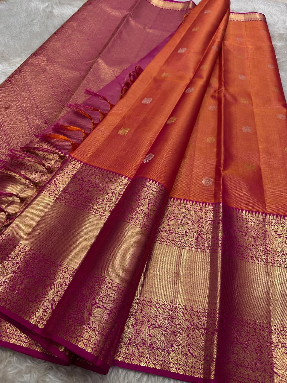 Vairaoosi - silk Kanchipuram thanga velli ( sonaroopa) zari butta in a mesmerizing rust red korvai getti (thick ) zari border with mayil motif