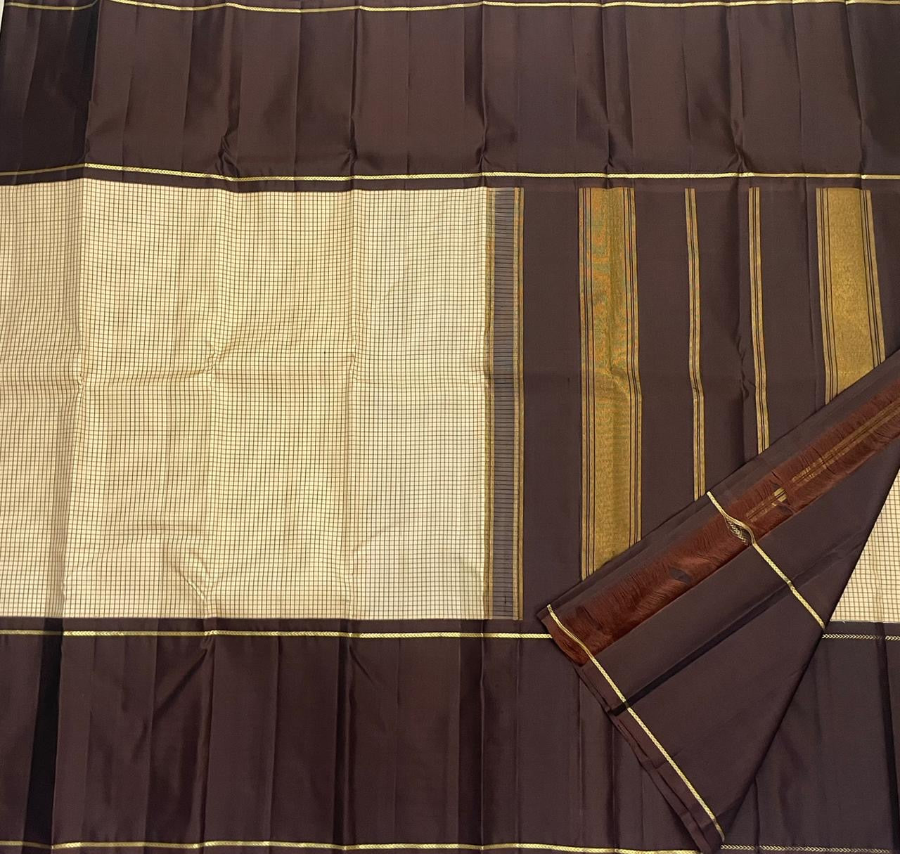 ✨ Siri Kattam — Pure Silk Kanchipuram Saree ✨
A refined butter-cream micro kattam body paired with deep coffee-brown panels, gold rope-zari borders and a zari pallu.
Silk Mark Certified • Free USA Shipping • Ships in 2  weeks , blouse stitching $30