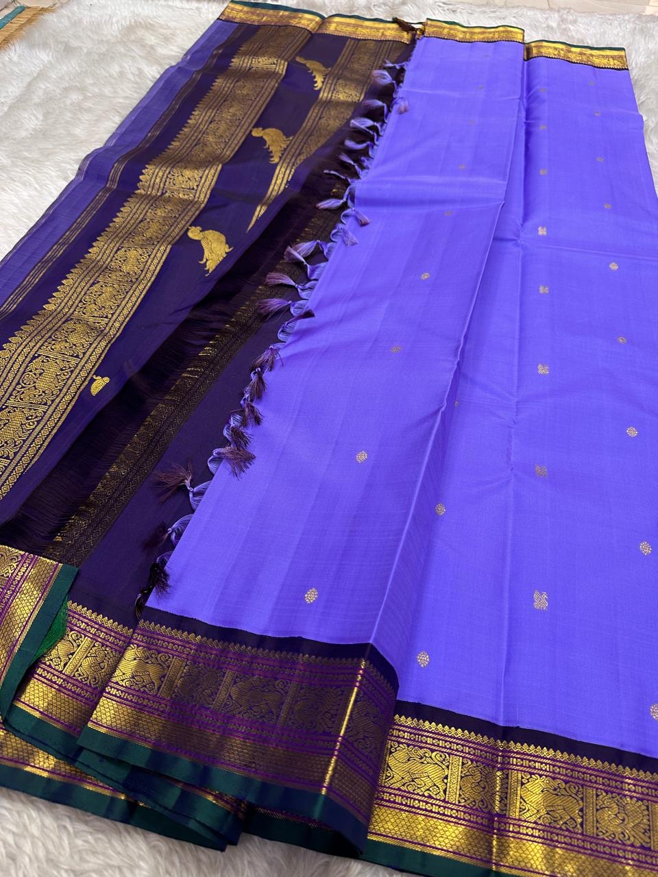 Kili kanchipuram beautiful purple and violet combination adorned with kili and kamalam butta , vanasringaram border and green selvedge with parrots parading in Pallu