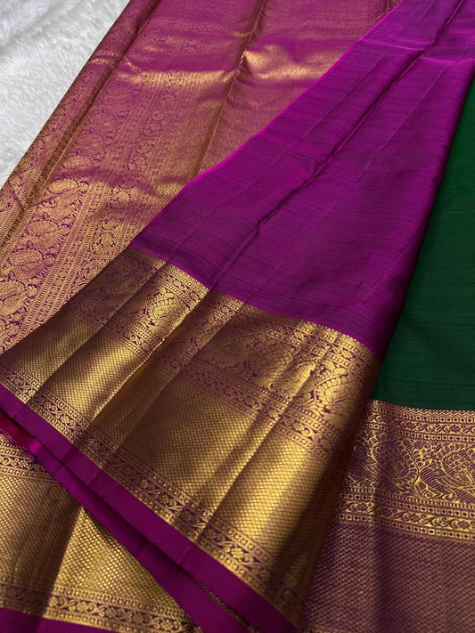 Maragatha Mayil Butta — Kanchipuram Pure Silk
Emerald green (maragatham) body with gold mayil/peacock buttas
Contrast rani-magenta korvai borders & zari-rich pallu
Silk Mark Certified | Free Shipping within USA