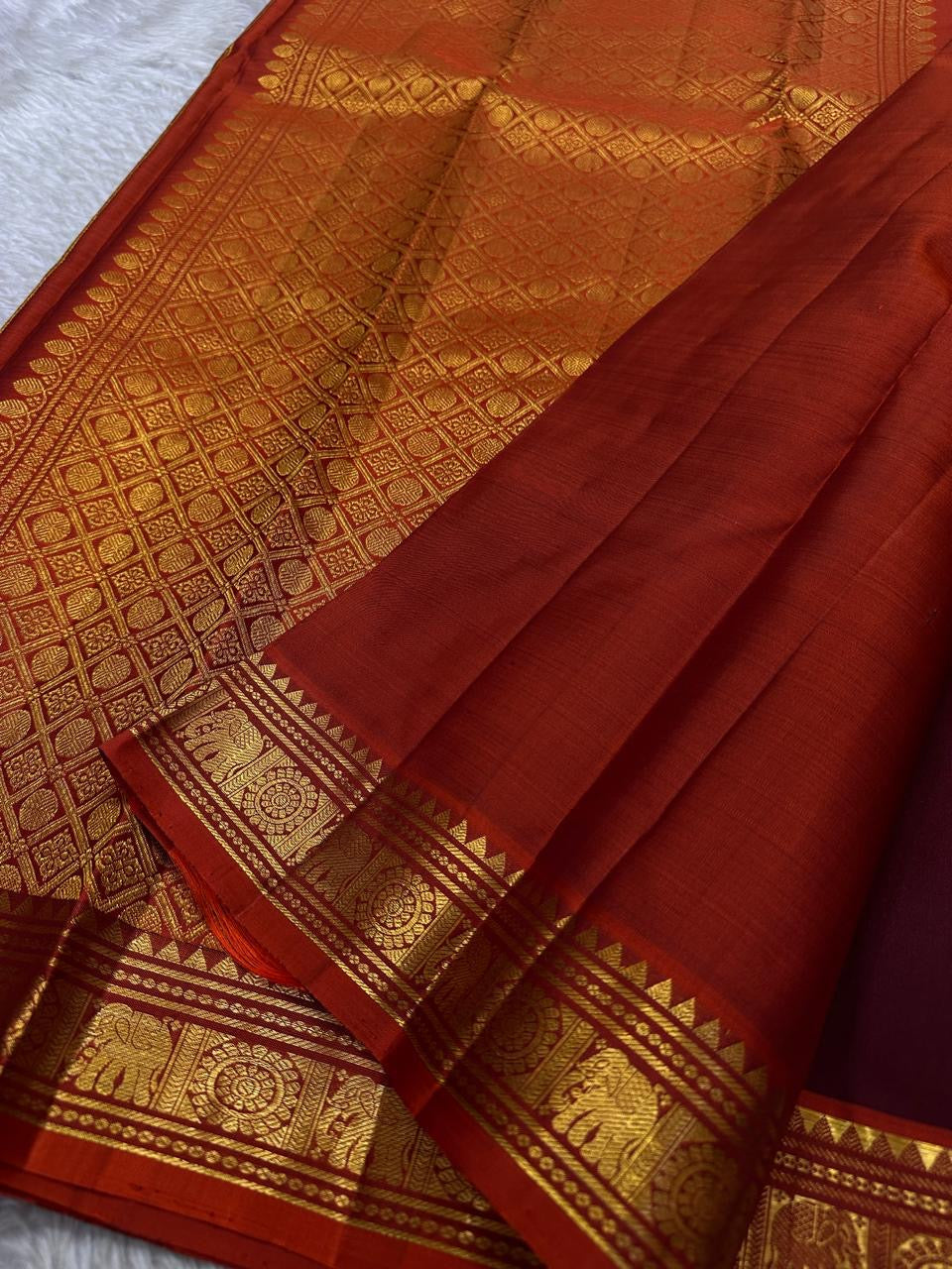 Maroon Kolam Korvai – deep wine-maroon body with tiny kolam buttas
Contrast burnt-orange korvai border with temple triangles & intricate kolam motifs
Silk Mark Certified | Fall & Pico Done | Blouse Stitching Available ($30)
Free Shipping 2 weeks
