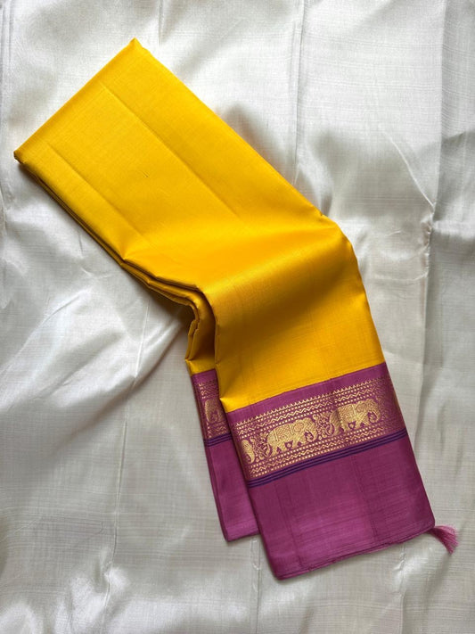 Yellow pure Kanchipuram Silk Saree with Kaal Erangina pink Zari Border