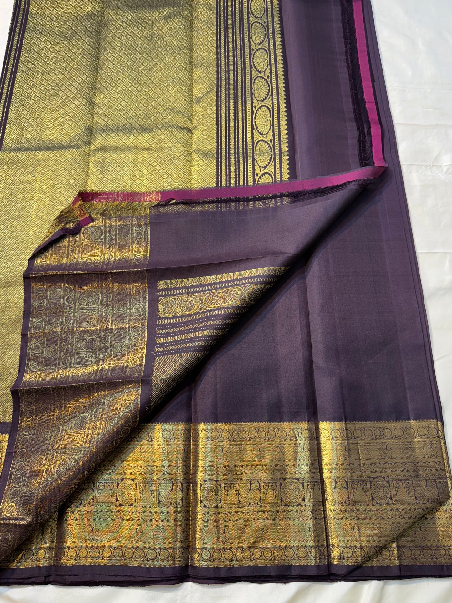 Deep Plum Coin Zari (Pure Kanchipuram Silk)
 Aubergine/plum body with gold chakram & mayil buttas
Self deep-purple border with antique-gold kasu-mālai (coin) motifs
Silk Mark Certified • Free USA Shipping • Ships in Two Weeks
