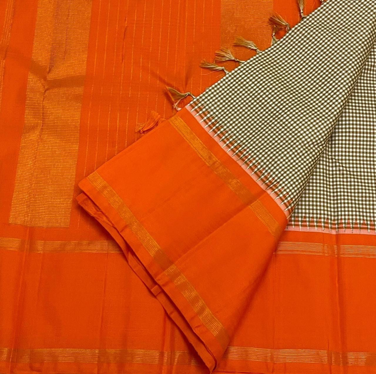Rust Kattam Korvai – Pure Silk Kanchipuram Saree
Olive–Ivory Micro-Checks Body with Korvai Join
Rust Orange Border
Rust Orange Pallu pillayar Reku
Comes with Matching Rust Orange Blouse Piece with Zari Border silk mark certified - ships in 2 weeks
