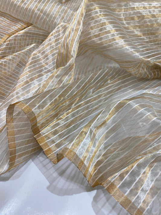 A delicate blend of gold and ivory woven in sheer Chanderi silk.The tissue finish adds a subtle shimmer to every fold Lightweight & graceful!