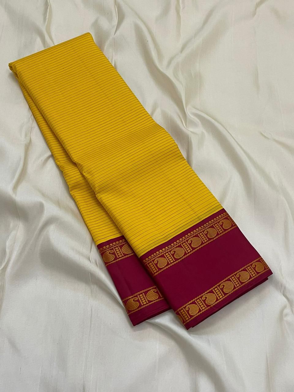Arakku Kanakam — Pure Silk Kanchipuram Saree
Basanti yellow body with fine varisai pinstripes and rich arakku korvai borders adorned with gold shankh motifs ✨
Silk Mark Certified • Free USA Shipping • Ships in Two Weeks ✅