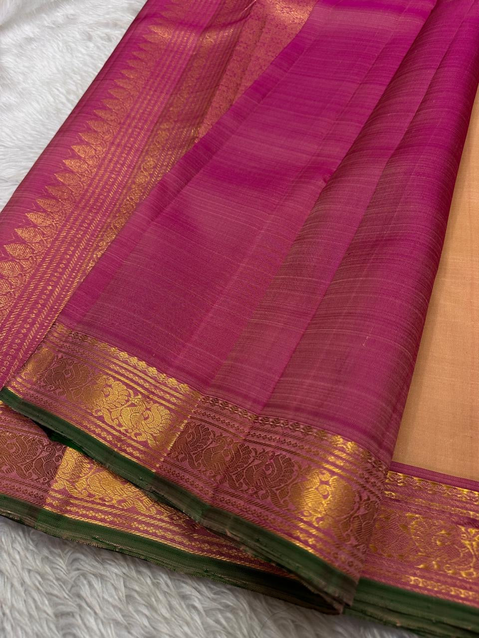Pure silk kanchipuram Biscuit beige color body with zari buttas , magenta mayil border with green selvedge