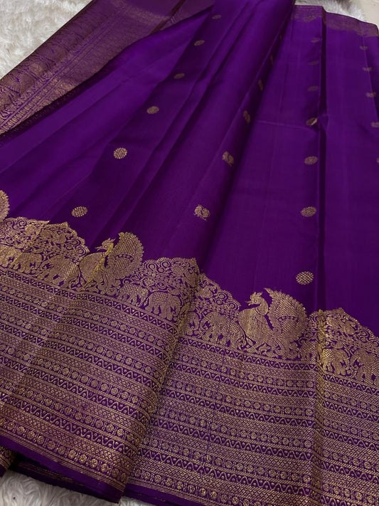 Lotus Glow — Violet | Pure Kanchipuram Silk Saree
A royal violet canvas with antique-gold zari peacocks, elephants & lotus motifs ✨
Silk Mark Certified • Free USA Shipping • Ships in Two Weeks