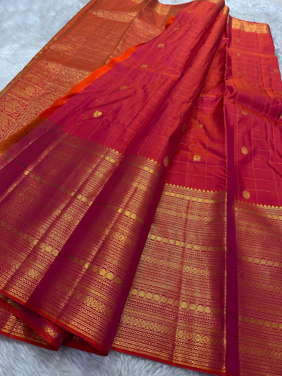 Orange red shot Zari kattam with ornate border pure silk Kanchipuram with mayil chakram zari butta and detailed Pallu