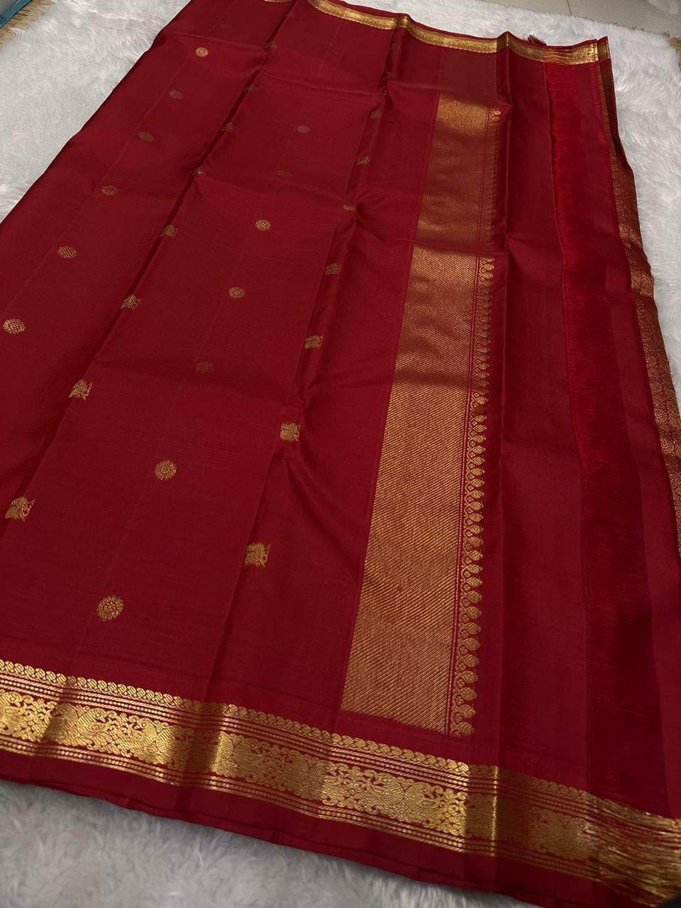 Ratna Rekha — Pure Silk Kanchipuram Saree
Deep kumkum red body with gold coin buttas, rich woven zari jaal pallu, and antique-gold floral borders.
Silk Mark Certified • Blouse Stitching ($30) • Free USA Shipping • Ships in 1 Week