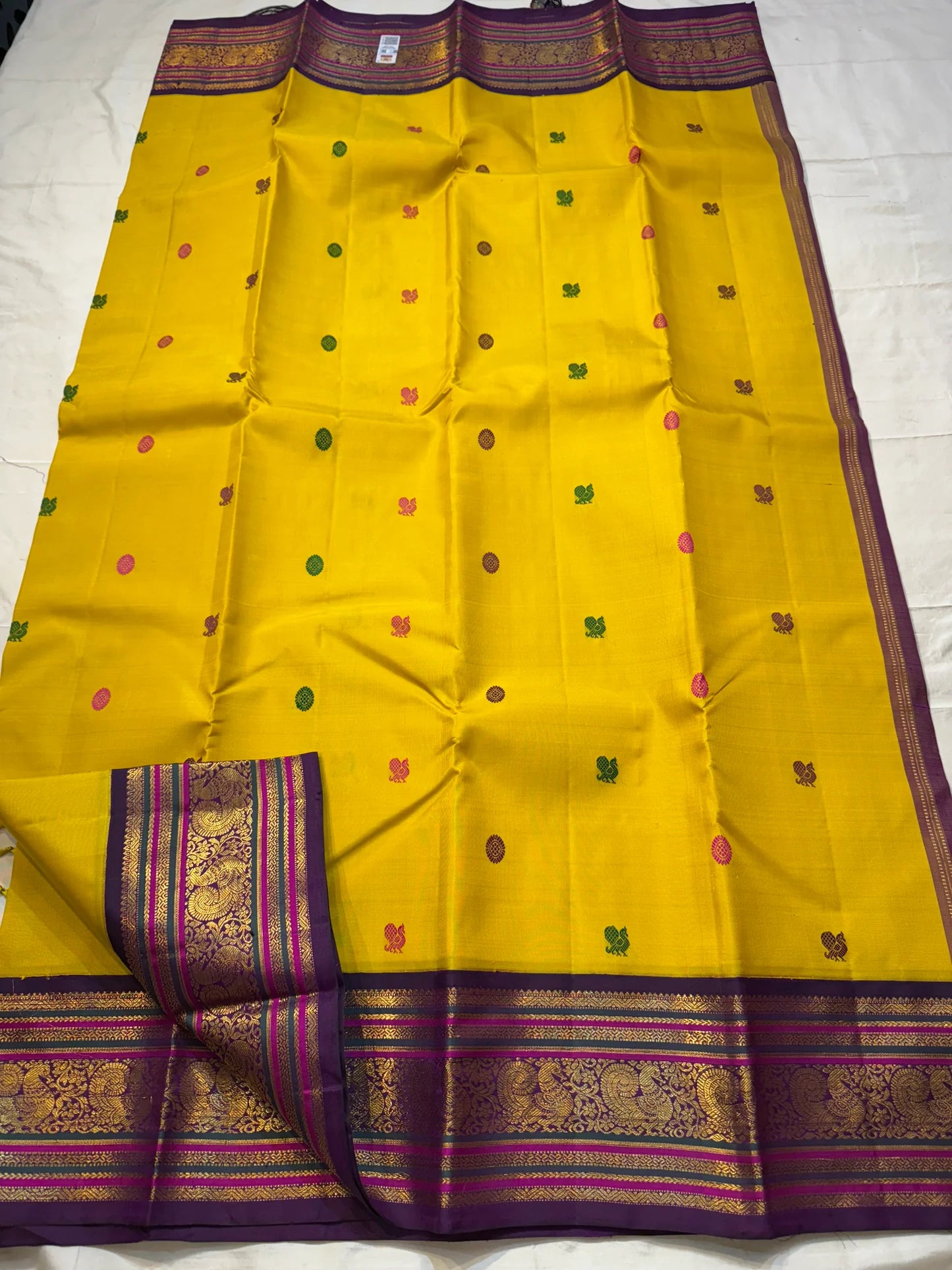 Kili Manjari — Pure Silk Kanchipuram
Haldi Yellow • Parrot & Coin silk thread Buttas • Plum Zari Border
Silk Mark Certified ✅ Free  Shipping ✅ Ships in 1 week ✅