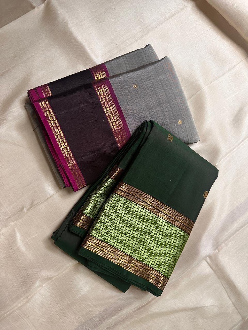 Ash Gulabi Chakram — Pure Kanchipuram Silk Saree
Elegant ash-grey body with gold zari chakram buttas, rich gulabi korvai borders, and deep violet zari pallu.
Silk Mark Certified • Blouse Stitching Available ($30) • Free Shipping within USA • 2 weeks