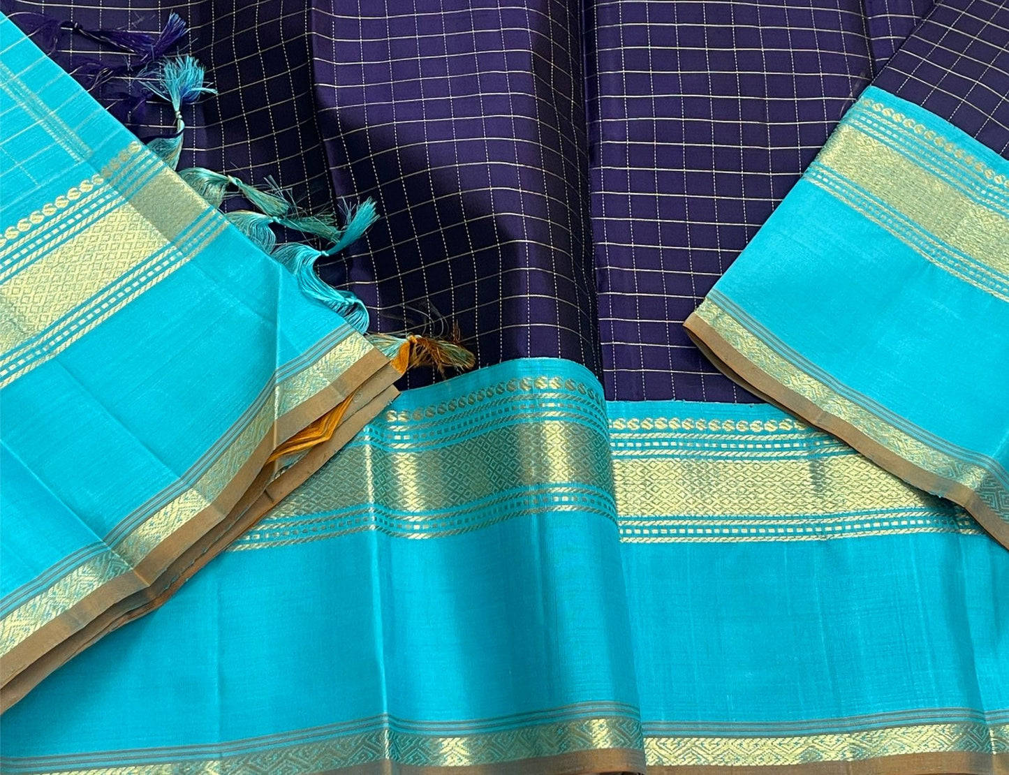 Indigo Teal Kattam – Pure Silk Kanchipuram Saree
Deep Indigo Body with zari Kattam Checks
Teal Contrast Korvai Border with maanga pet and mayil kann border, maanthulir selvedge , silk mark certified -ships in two weeks