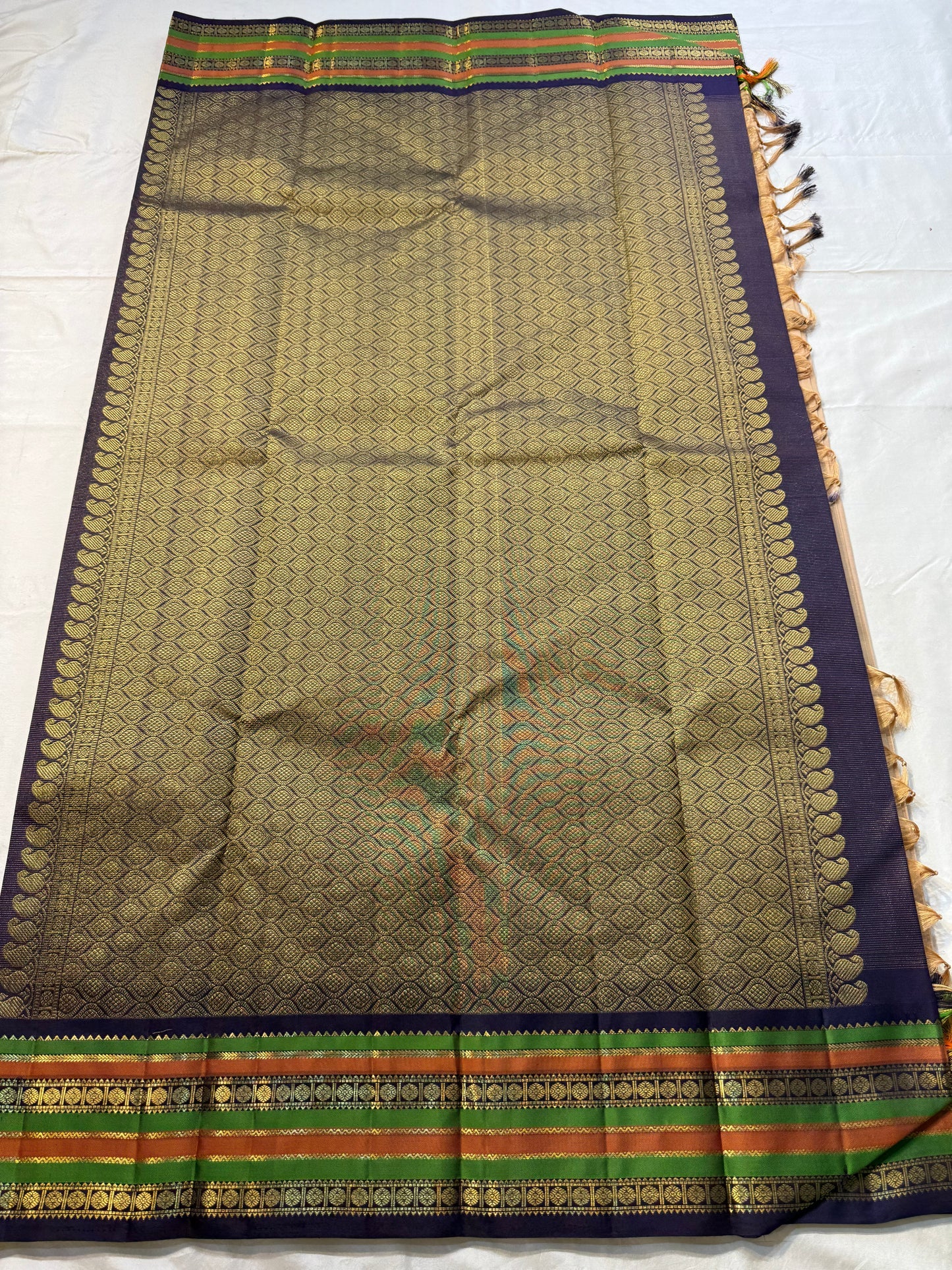 Sandal Temple – Pure Silk Kanchipuram Saree
Sandal Body with mild sheen , pillayar moggu ✨
Indigo-Purple Korvai Border with Green & Ochre Stripes
Temple Gopuram Zari Edging & Grand Brocade Pallu
Silk Mark Certified | ships in two weeks