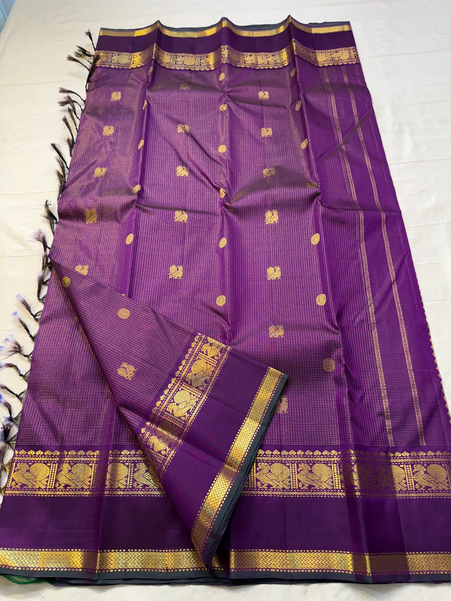 Kalika Purple — Pure Silk Kanchipuram Saree
Royal Purple with Gold Coin & Kalika Paisley Zari Buttas | Annapakshi Panel Border | Brocade Pallu
**Silk Mark Certified ✅ •ships in 2 weeks