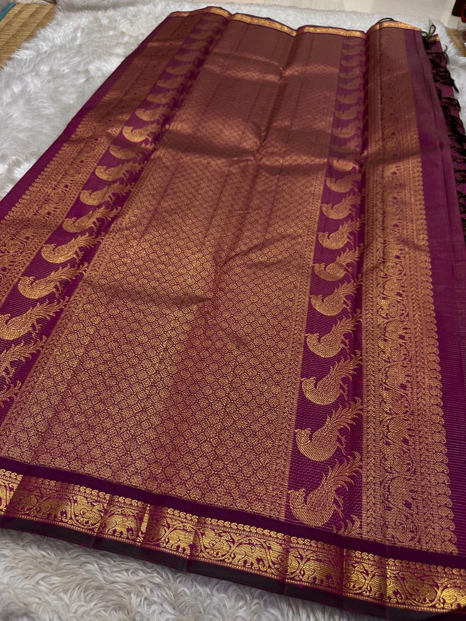 Purple Mayil Vairaoosi — Pure Silk Kanchipuram Saree
Royal purple body in fine vairaoosi pin-stripes with gold mayil motifs
Antique-gold zari borders, copper-rose brocade pallu & black selvedge ✨
Silk Mark Certified • Free USA Shipping • Ships in Two Week