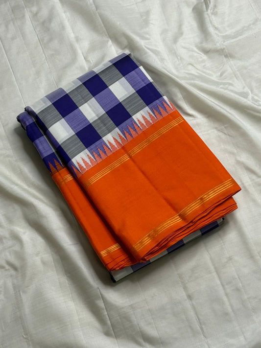 Lilac Indigo Kattam — Pure Silk Kanchipuram Saree
Bold indigo–lilac–white checks with tangerine korvai borders & gold temple edging
Silk Mark Certified • Free USA Shipping • Ships in Two Weeks