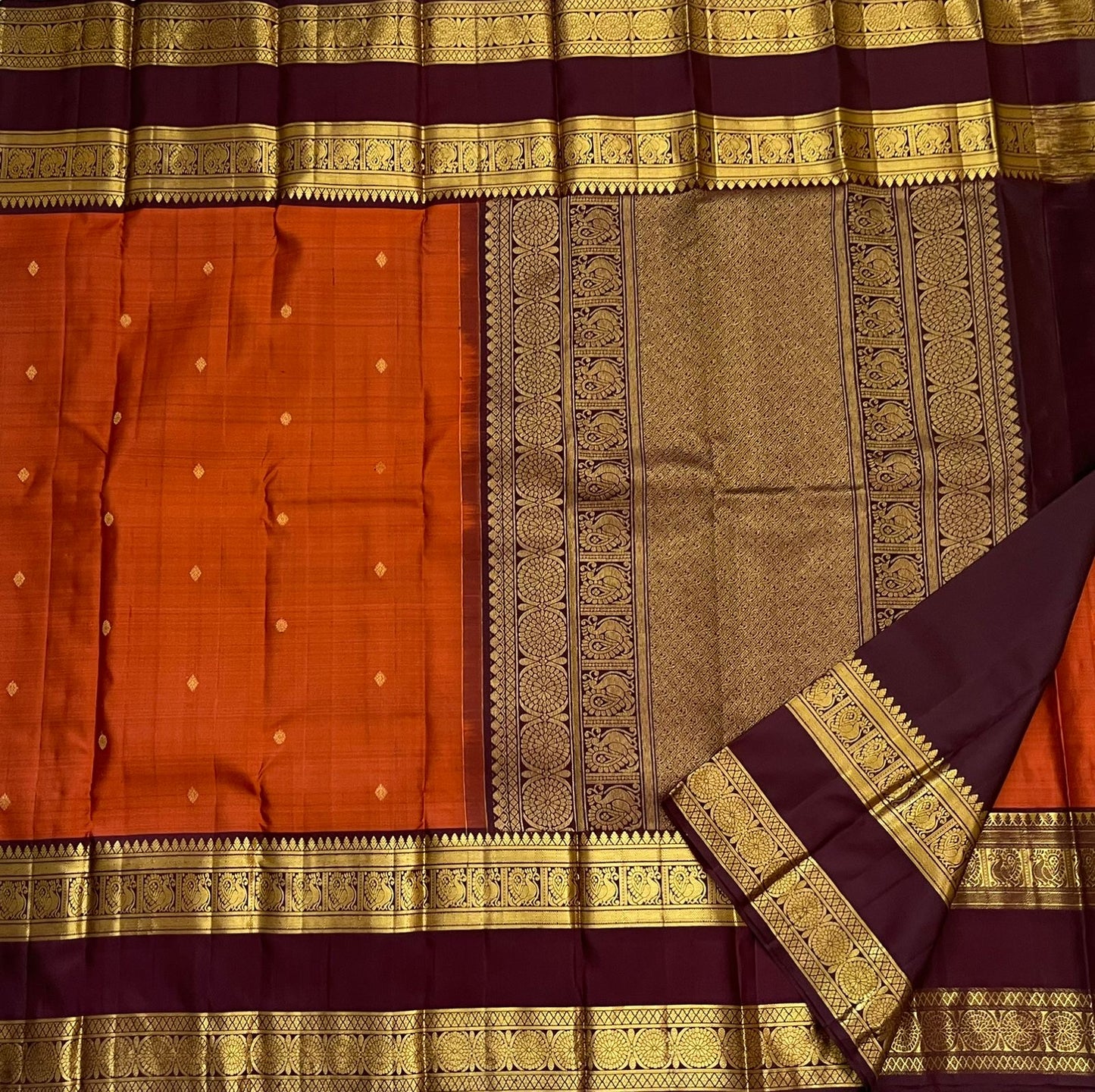 Rust Orange Ramyam – Pure Kanchipuram Silk Saree
Rust-orange body with pavin coin  buttas
Deep brown border with peacock panel & chakra medallions; grand zari pallu
Silk Mark Certified | Blouse Piece Included | Fall & Pico Done
Free Shipping in 1 week
