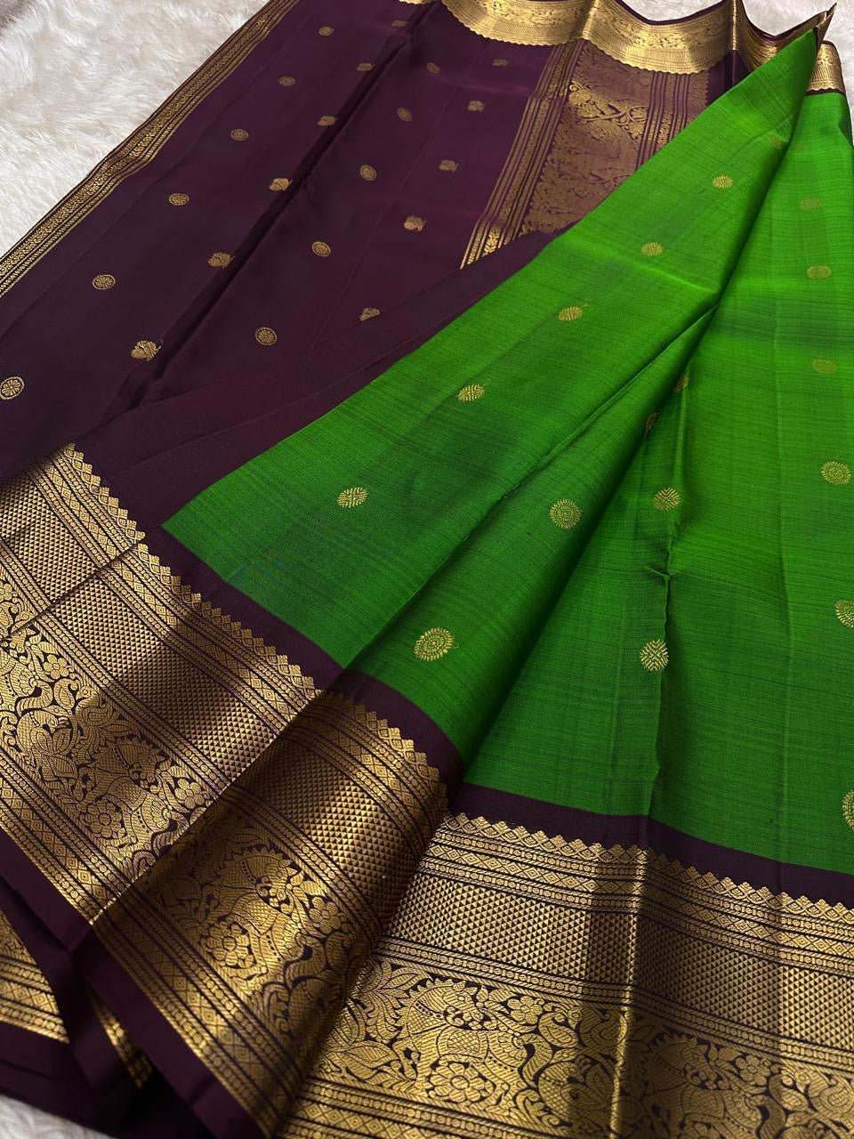 Harita Butta Brown – Pure Silk Kanchipuram
Harita-green body with gold buttas & aubergine-brown zari border
Silk Mark Certified • Free USA Shipping • Ships in Two Weeks
