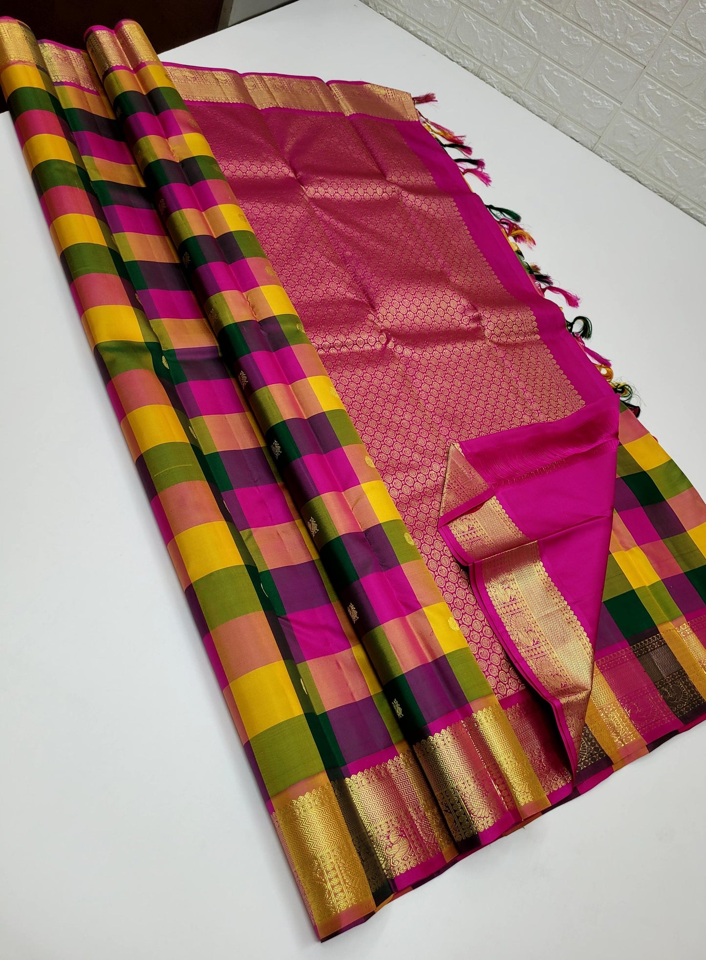 Sunset Mosaic – Paalum Pazhamum – Pure Kanchipuram Silk Saree
Vibrant Multicolored Checks in Yellow, Green, Rust & Maroon
Golden Zari Borders with Traditional Intricate Weaves
Silk Mark Certified, delivery in 2 weeks
