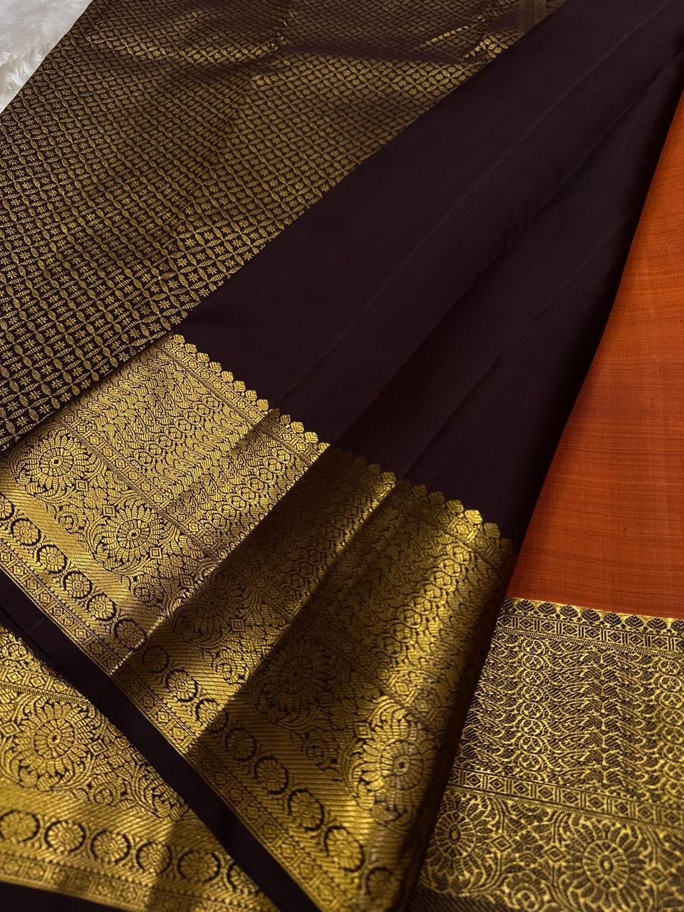Gilded Rust Orange + Paaku Nut Brown — Pure Silk Kanchipuram
Rust-orange body with gold coin buttas & deep nut-brown korvai border in grand medallion zari
Silk Mark Certified • Free USA Shipping • Ships in Two Weeks ✅