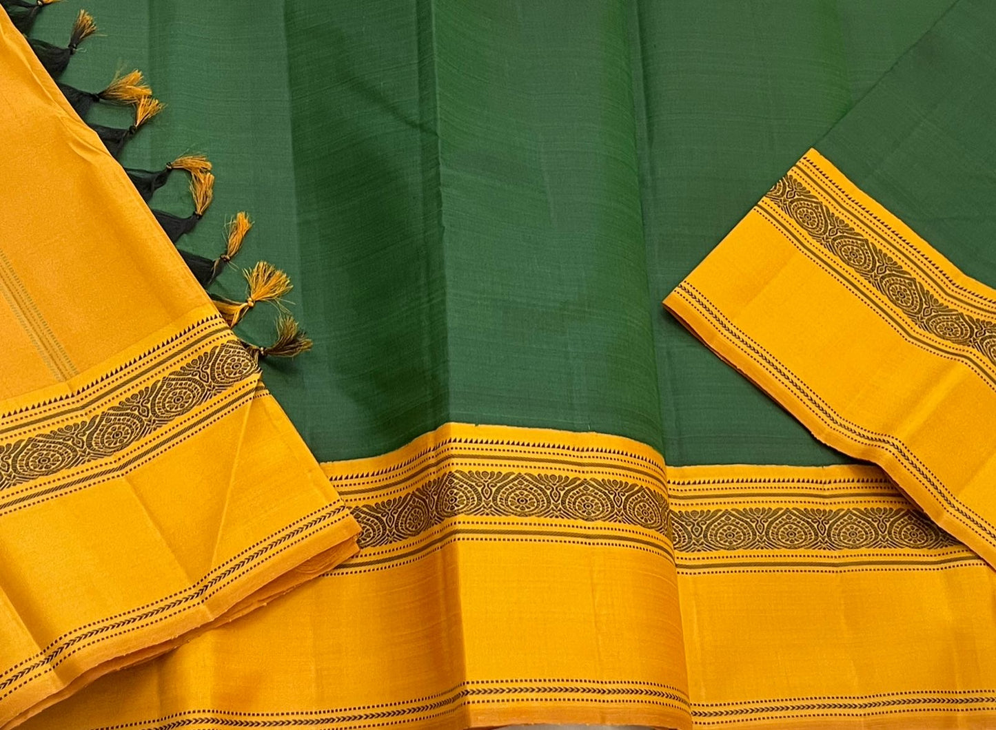 Maragatham & Mustard — Pure Silk Kanchipuram Saree
Emerald-green body with mustard korvai borders & floral medallion vines, varisaipettu pallu with tassels.
Silk Mark Certified • Ships in Two Weeks • Free USA Shipping ✅
